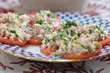 Bright festive appetizer of fresh tomatoes on a beautiful dish. An ideal addition to a celebration, feast, party, decoration of any table