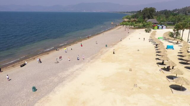 Aerial View of beach with thatched umbrellas, China.