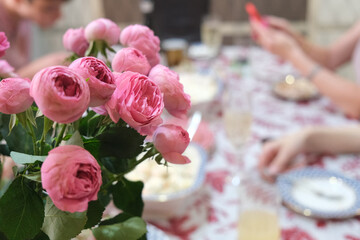 An exquisite bouquet of delicate pink roses decorates a festive table. Concept for a celebration, birthday, special occasion, feast with friends and family