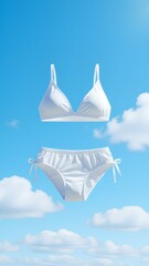 A white two-piece bikini gracefully floats against a vibrant blue sky with clouds. This clean, conceptual image evokes summer travel, beach holidays, and vacation freedom, perfect fo