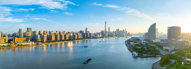 Panoramic Aerial view of Shanghai skyline and winding river in downtown at sunset.