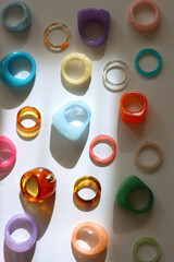 Collection of colorful plastic rings on white background. Top view.