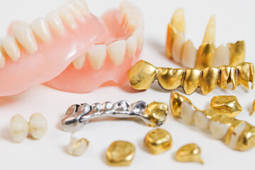 Various false teeth closeup on white