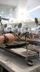 person barista using modern grinder machine to prepare coffee grounds in cafe features digital...