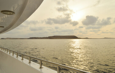View from the yacht on the sparkling sea and the desert coast of the Red Sea