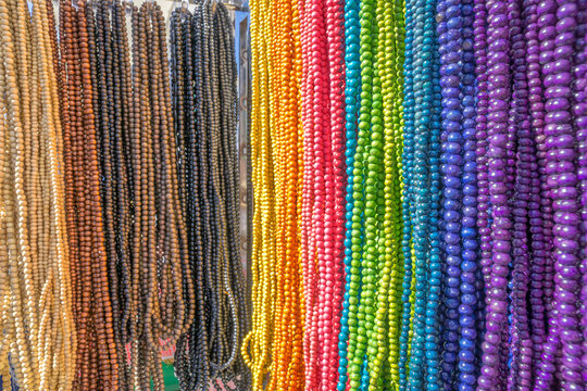 A close up of a rack of rainbow coloured beads