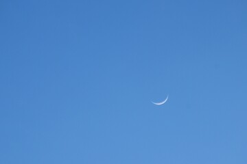 half moon floating on blue sky in twilight background 
