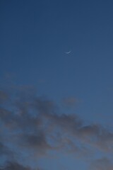 half moon floating on blue sky in twilight background 