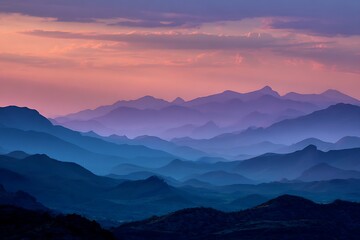 Fototapeta premium Sunset ridge silhouette with blue and purple mountain layers 