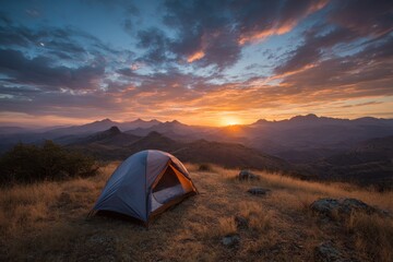 Stunning sunset over mountains with tent in serene camping spot