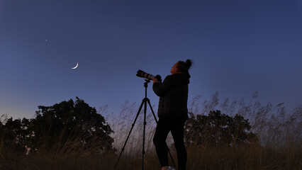 Amateur astronomer using camera and lens for photographing stars, Moon, planets and other celestial...