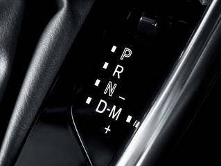 Closeup of car gear selector, automatic transmission display. Shifter, P R N D M modes.