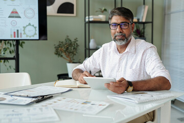Businessman with tablet in modern office setting