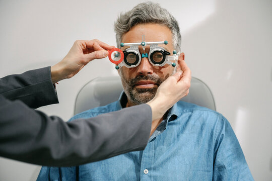 Optometrist conducting a vision test on a patient with corrective lenses