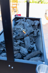 Charcoal grill igniting with bright flame outdoors