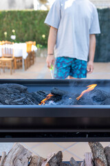 Outdoor grilling enthusiast preparing barbecue fire