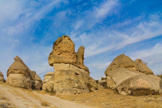 Cappadocia valley in Turkey. Cappadocia rock formation sites and chimneys Love Valley. Tuff volcanic rock pillars and mushrooms in the museum under open sky in Cappadocia turkish famous tourist sight