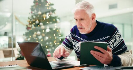 Man, tablet and laptop at Christmas in office with smile for revenue, results and good news. Person, happy and tech at xmas with computer for profit increase, app or notification at financial agency - Powered by Adobe