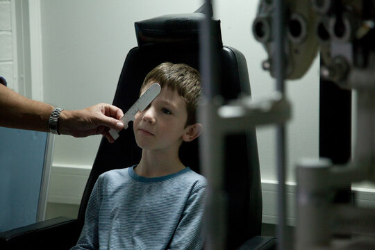 Young boy at an optometrist appointment getting his vision tested