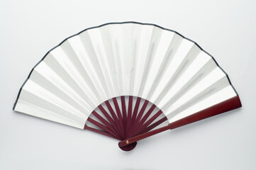 Folding paper bamboo fan on pink background. Chinese or japanese blank fan for sublimation.