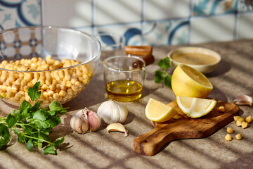 Chickpeas, lemon, tahini and herbs, ingredients for making hummus