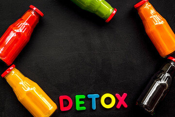 vegetable and fruit juice in bottles for detox drink on black background top view mock up