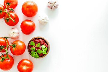 Tomato frame with suase and garlic on white background top-down copy space