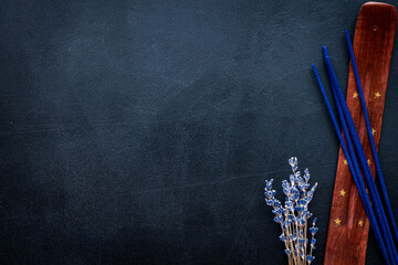 incense sticks with lavander for fresh air on dark background top view mock up
