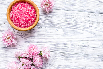 aroma therapy with pink flower fragrance and spa salt on white wooden background top view space for text