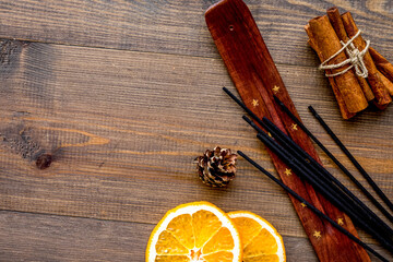 citrus and cinnamon fragrance diffuser for air freshness on wooden background top view mock-up