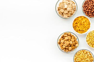 cereals, oatflakes and cornflakes for healthy breakfast on white background top view mock up