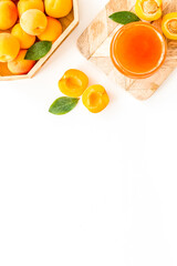 Summer preserves. Apricot jam in jar near fresh fruits on white background top view frame copy space