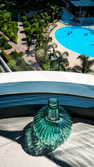 Sunlit Glass Bottle with Pool and Modern Architecture