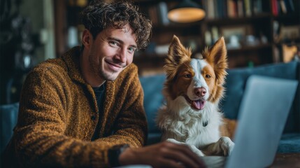 Smiling man working with laptop at home accompanied by a friendly dog