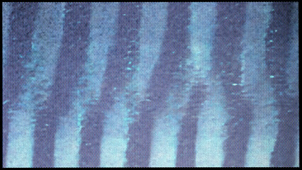 close-up of the screen texture of an old VHS video tape file, with a blue color dot background and...