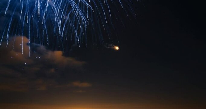 Spectacular blue fireworks explode in the night sky