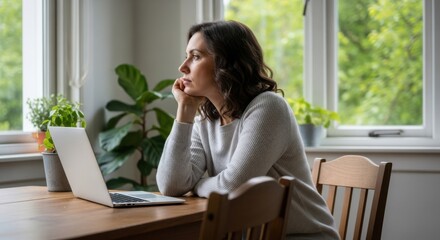 Woman Thinking Deeply by the Window with Laptop