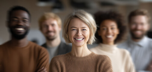 Obraz premium Standing at forefront in a modern office, confident professionals, led by young businesswoman, represent authority, charisma, and clarity of effective leadership.