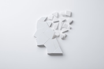 Deconstructed mind concept shows mental health with scattered white shapes on a white surface suggesting abstract issues.