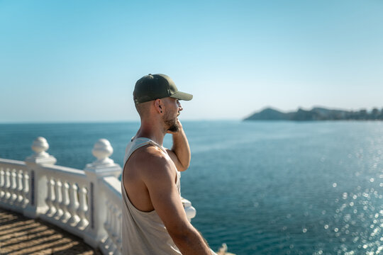 Man enjoying scenic ocean view from balcony