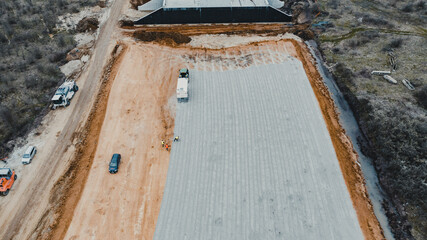 Aerial Overlook of Construction Machinery at Work on Developing Terrain, Workers On Site