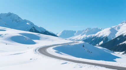 Obraz premium Winding Road Through Snow-Covered Mountains Under Clear Blue Sky