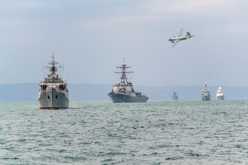 A formation of warships and aircraft sail in the Black Sea during a peacekeeping operation.
