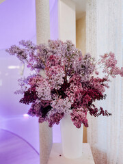 Vibrant bouquet of lilac flowers in a stylish arrangement at a modern venue