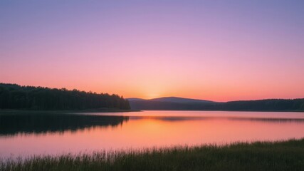 Fototapeta premium Sunset Over a Calm Lake with Reflections and Silhouetted Trees