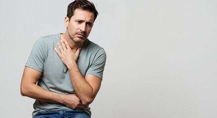 Man feeling unwell, clutching his throat and stomach, showing signs of discomfort or illness.