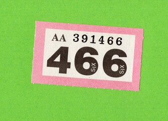 A single raffle ticket isolated on a brightly coloured background.