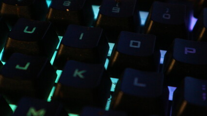 Fototapeta premium Close-up view of illuminated keyboard keys, showing colorful backlighting.