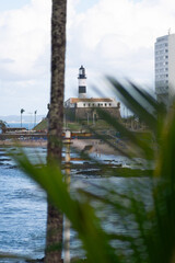 View from afar of the Barra Lighthouse, a famous postcard of the city of Salvador, Brazil.