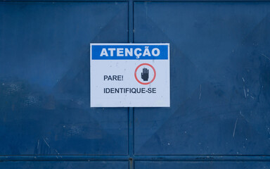 sign requesting identification to enter. Street in the city of Salvador, Bahia.